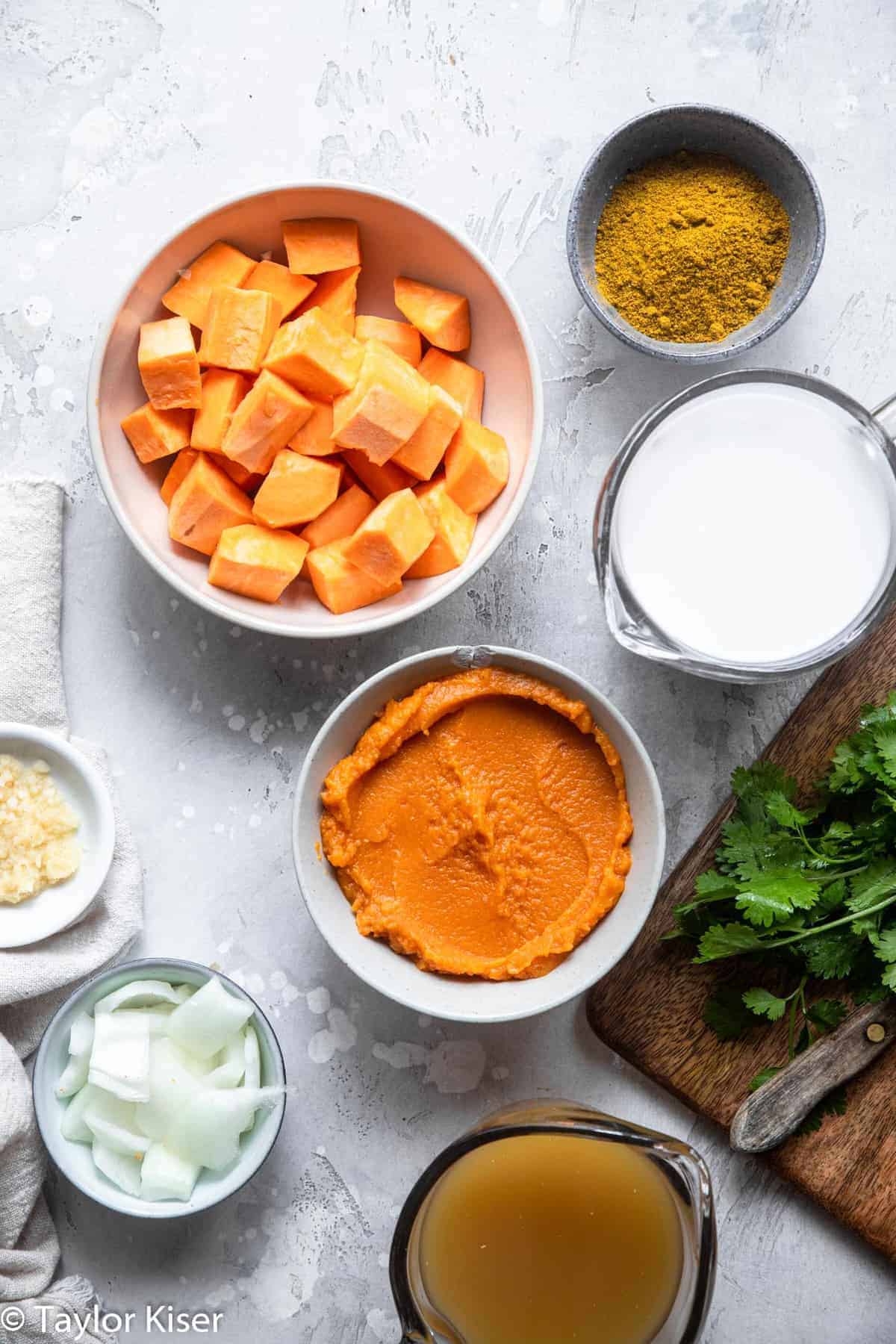 Life Changing Vegan Pumpkin Curry - My husband said this was the best curry he ever had! An easy, 30 minute meal that is naturally gluten free, paleo, whole30 and healthy too! A must make for fall! | #Foodfaithfitness | #glutenfree #paleo #whole30 #vegan #healthy Ingredients to make a pumpkin curry recipe on a table