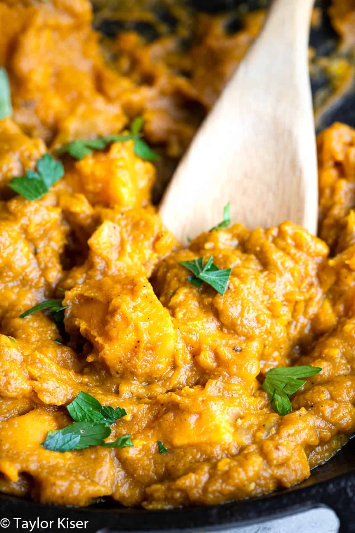 Life Changing Vegan Pumpkin Curry - My husband said this was the best curry he ever had! An easy, 30 minute meal that is naturally gluten free, paleo, whole30 and healthy too! A must make for fall! | #Foodfaithfitness | #glutenfree #paleo #whole30 #vegan #healthy Close up of Indian Pumpkin curry with cilantro on top