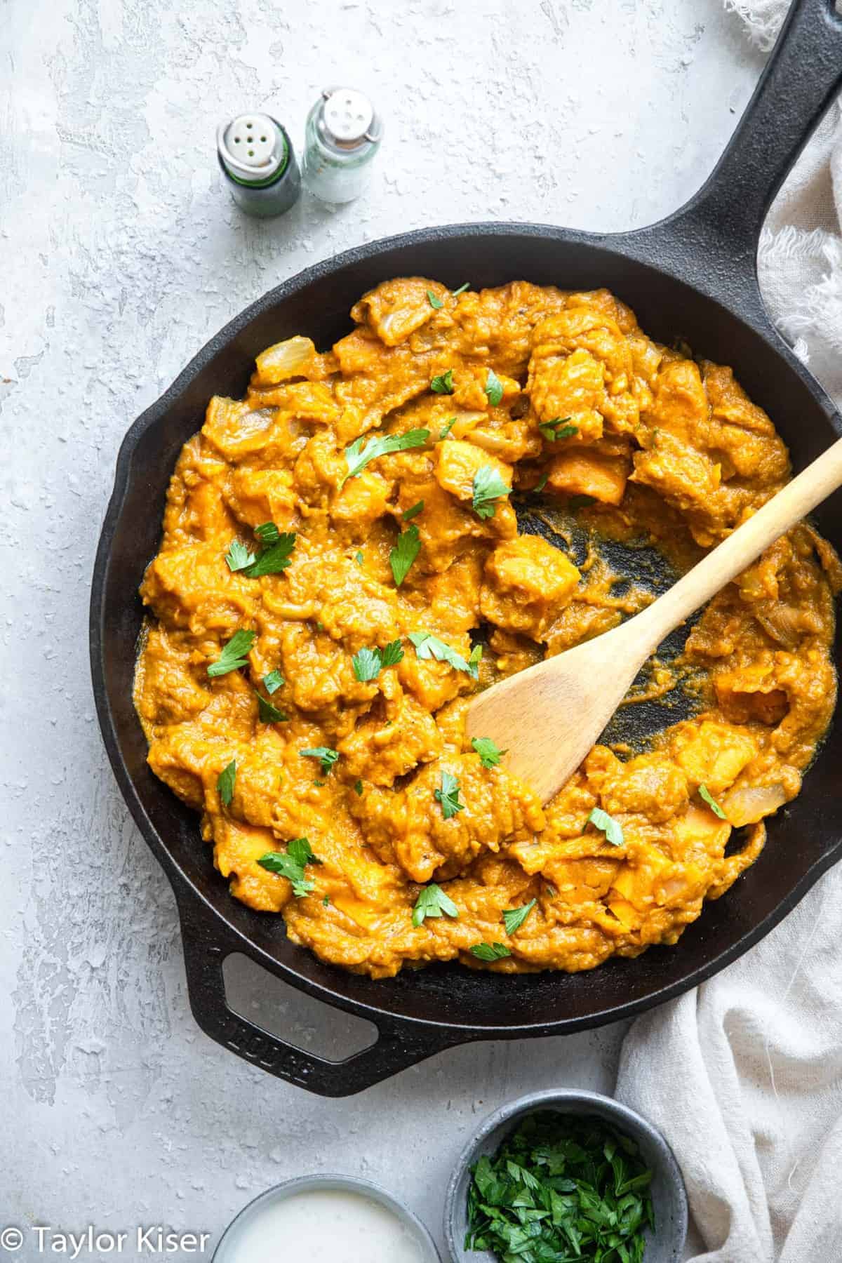 Life Changing Vegan Pumpkin Curry - My husband said this was the best curry he ever had! An easy, 30 minute meal that is naturally gluten free, paleo, whole30 and healthy too! A must make for fall! | #Foodfaithfitness | #glutenfree #paleo #whole30 #vegan #healthy Pumpkin coconut curry in a cast iron pan