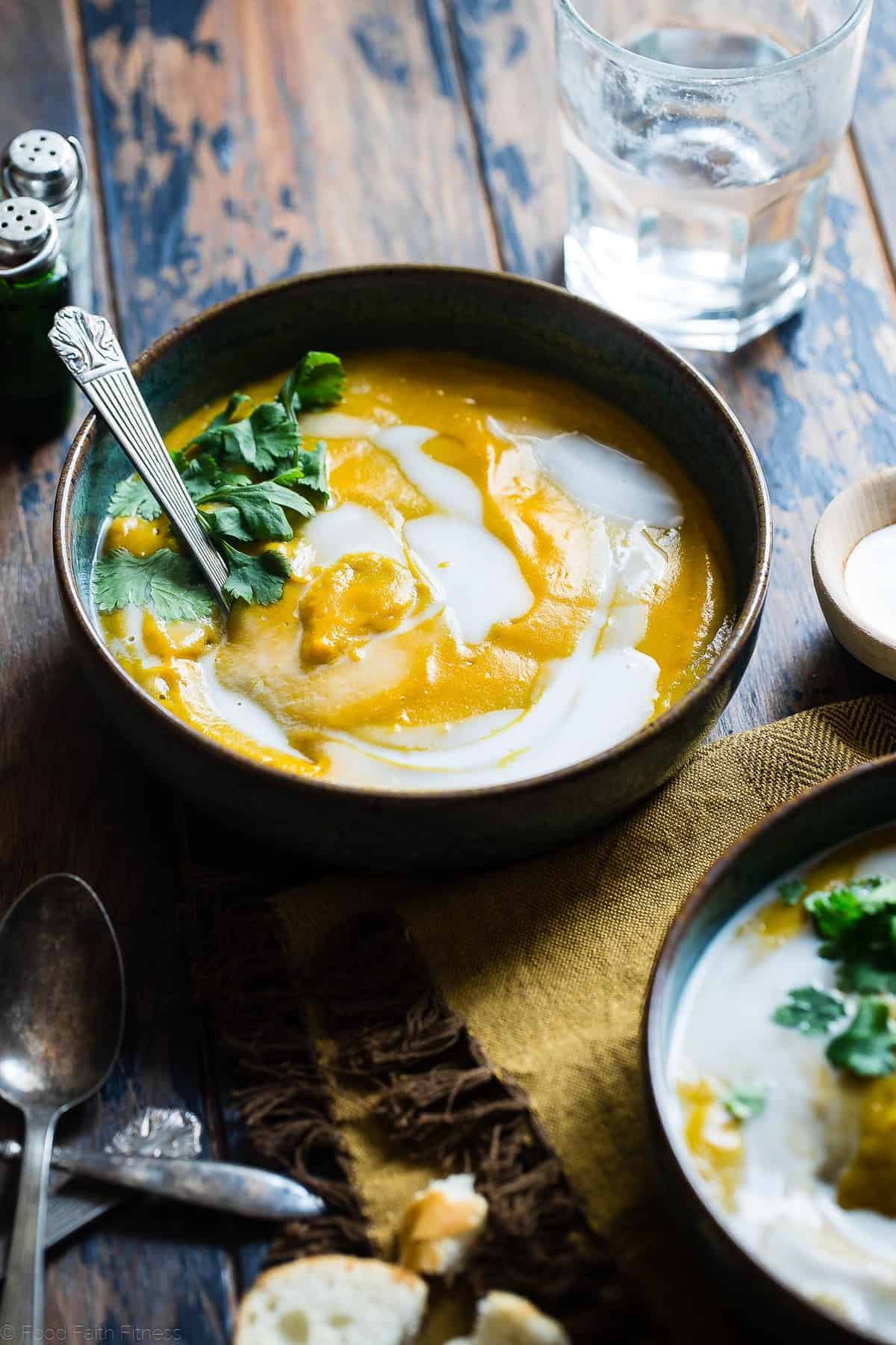 Coconut Curry Roasted Butternut Squash Soup - This spicy, paleo and vegan butternut squash soup is so creamy you'll never believe it's healthy, whole30 compliant and gluten and dairy free! | #Foodfaithfitness | #paleo #whole30 #vegan #dairyfree #soup Paleo Butternut Squash Soup in a bowl with spoon