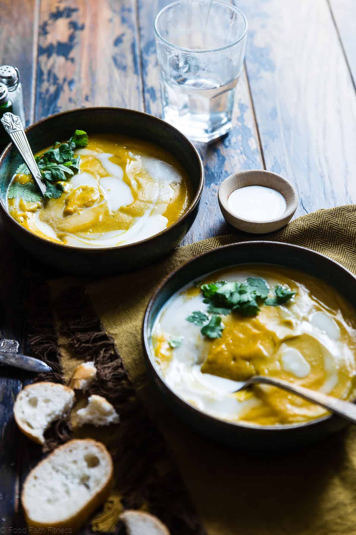 Coconut Curry Roasted Butternut Squash Soup - This spicy, paleo and vegan butternut squash soup is so creamy you'll never believe it's healthy, whole30 compliant and gluten and dairy free! | #Foodfaithfitness | #paleo #whole30 #vegan #dairyfree #soup Paleo Butternut Squash Soup on a table with bread on the side