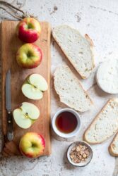 Ingredients for Brie Grilled Cheese with Apples: apples, brie cheese, bread slices, honey, and sliced almonds.