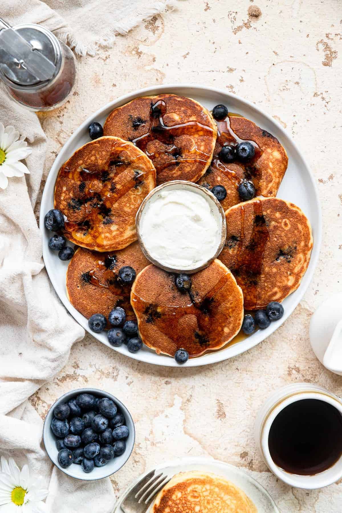 Blueberry pancake recipe on a large plat with sauce