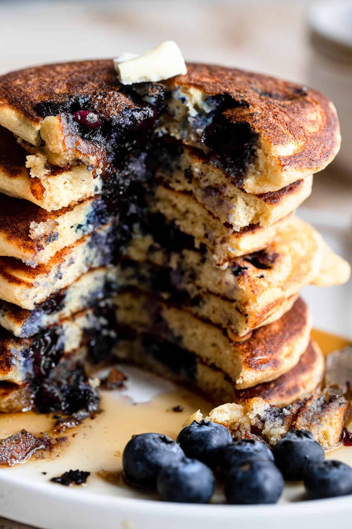 Whole Wheat Ricotta Blueberry Pancakes - These whole wheat blueberry pancakes are big, fluffy and creamy thanks to the addition of Ricotta Cheese! Easy, healthy and packed with protein! | #Foodfaithfitness | #glutenfree #healthy #wholewheat #pancakes Best blueberry pancake recipe picture of inside of pancakes