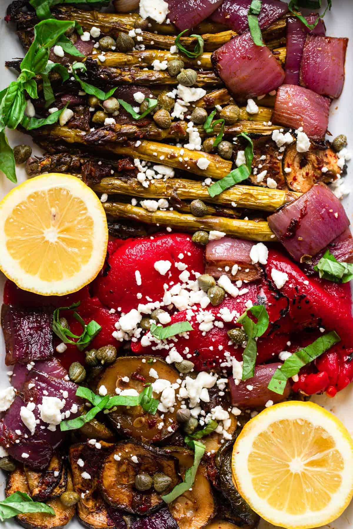Balsamic Grilled Vegetable Salad - This quick and easy balsamic grilled vegetable salad is marinated in topped with sun dried tomatoes and feta cheese. Healthy, gluten free and delish! | #Foodfaithfitness | #glutenfree #healthy #grilled #salad #vegetarian close up of balsamic grilled vegetable salad