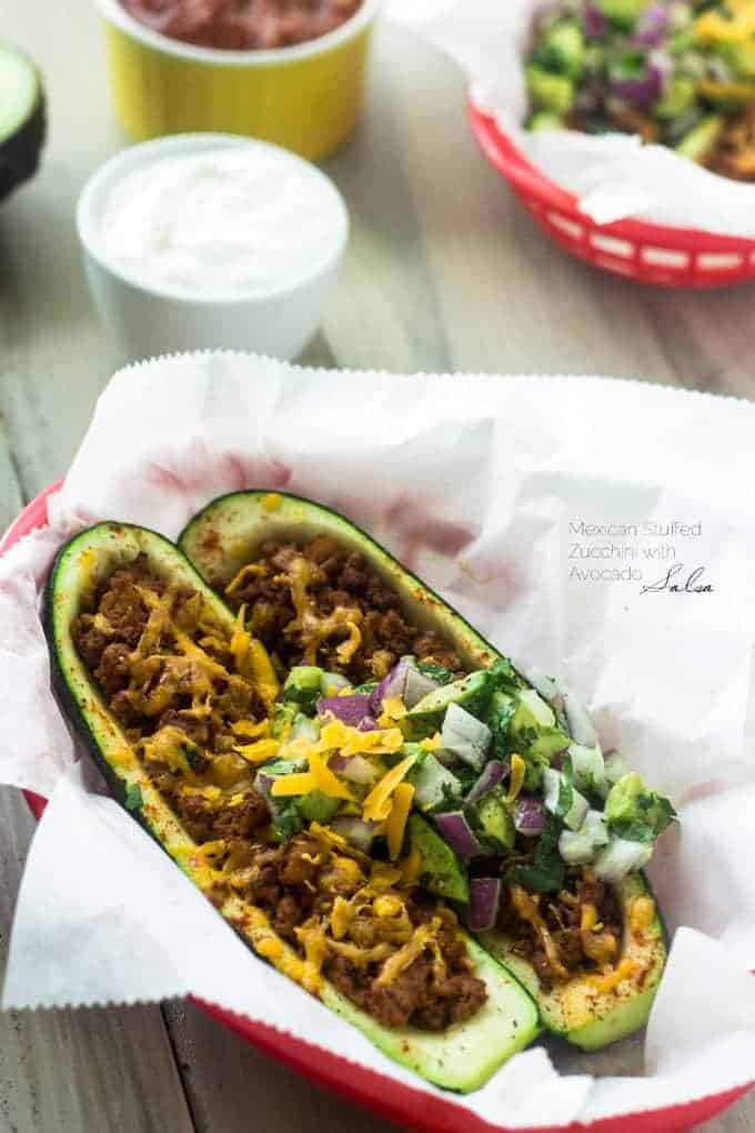 Mexican Stuffed Zucchini with Avocado Salsa - SO yummy, healthy and great for school nights! | Foodfaithfitness.com | #glutenfree #lowcarb #recipe #zucchini