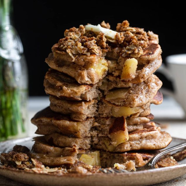 stack of healthy apple pancakes with a chunk eaten