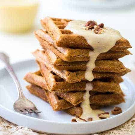 The Best Waffles with Eggnog Cream Sauce - Seriously. These are absolutely AMAZING! Light, crispy and perfect for Christmas morning! | Foodfaithfitness.com | #recipe