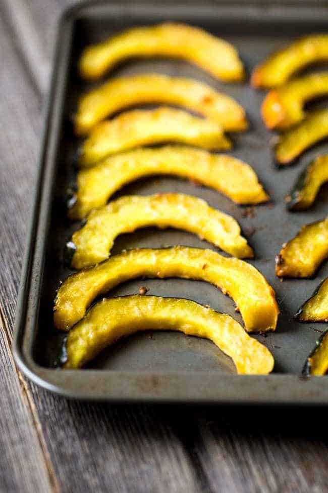 Pamesan Toasted Acorn Squash with Sage Kale Pesto - An easy side dish that is perfect for entertaining or a weeknight dinner! | Foodfaithfitness.com | #recipe