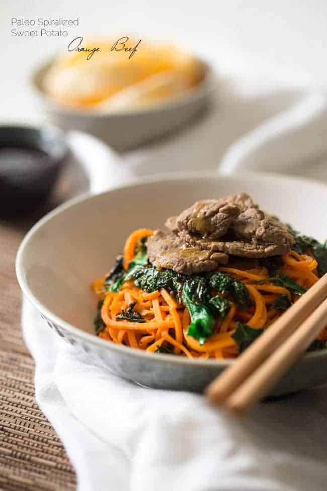 Spiralized Paleo Orange Beef Stir Fry with Kale and Sweet Potato Noodles - A healthy twist on takeout that is ready in 20 minutes! | Foodfaithfitness.com | @FoodFaithFit