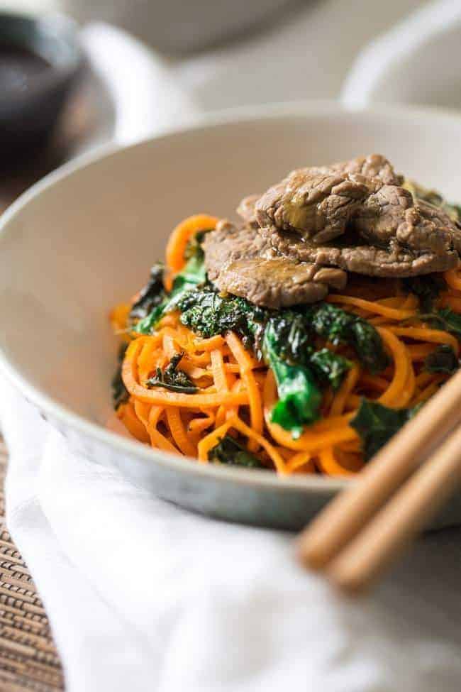 Spiralized Paleo Orange Beef Stir Fry with Kale and Sweet Potato Noodles - A healthy twist on takeout that is ready in 20 minutes! | Foodfaithfitness.com | @FoodFaithFit