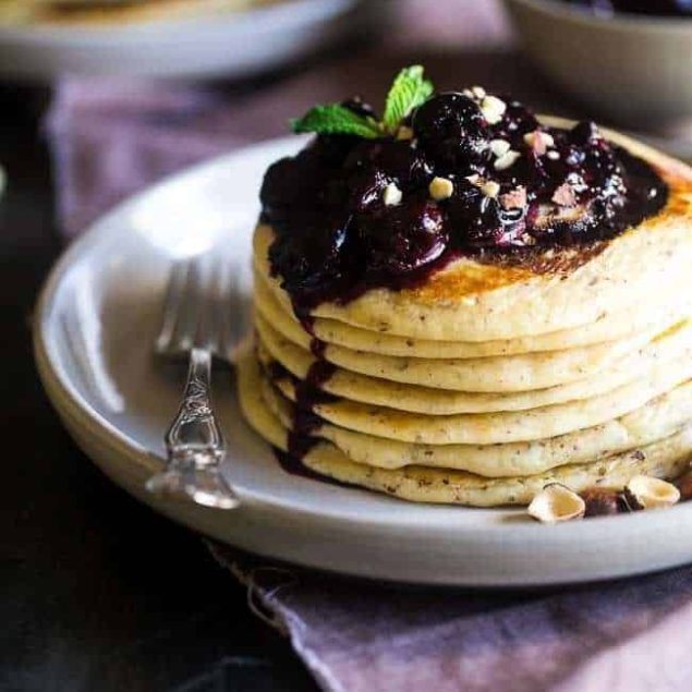 Chocolate Swirled Gluten Free Pancakes with Cherry Sauce and Hazelnuts – Ooey, gooey and so decadent! These pancakes are SO easy and perfect for Mother’s Day or brunch! | Foodfaithfitness.com | @FoodFaithFit