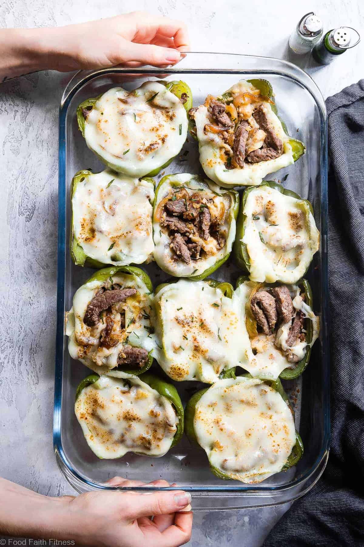 Low Carb Keto Philly Cheesesteak Stuffed Peppers - These stuffed peppers have all the flavors of your favorite sandwich in a healthy, low carb, easy weeknight meal that will please even picky eaters! Healthy comfort food at its best! | #Foodfaithfitness | #Glutenfree #Keto #Lowcarb #Healthy #Grainfree Cheesesteak Stuffed Peppers being served in a backing dish