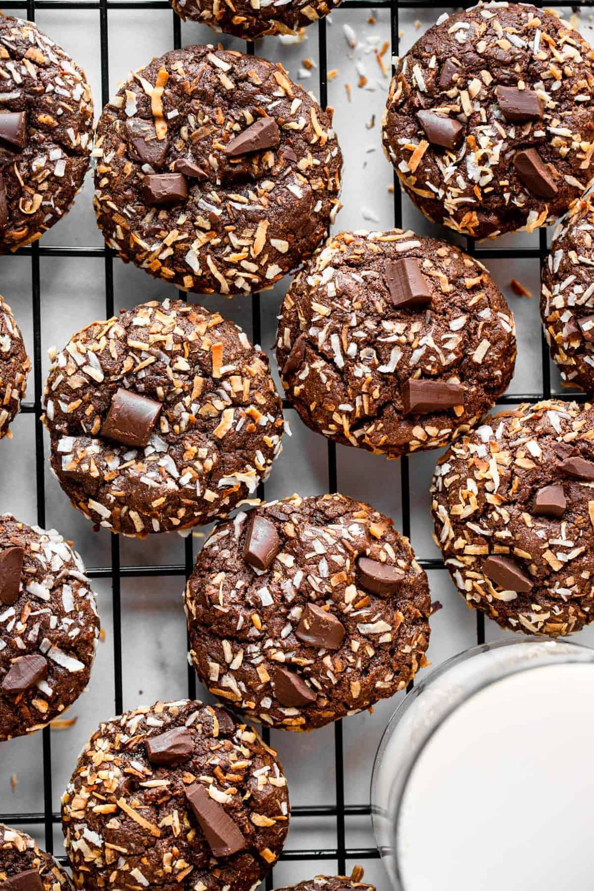 close up of quinoa cookies on a cooling rack with milk on the side
