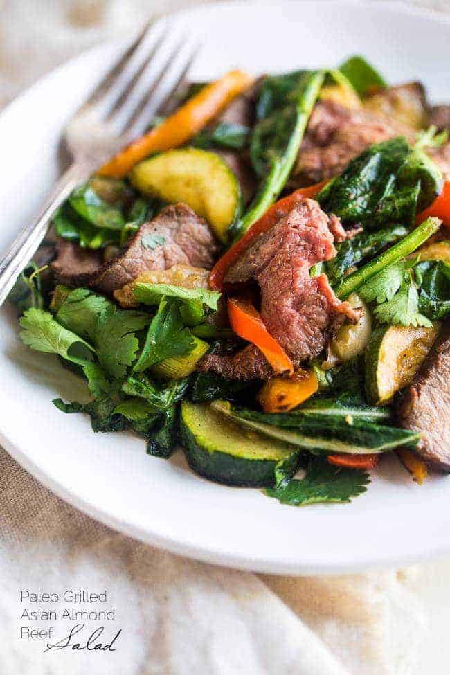 Paleo grilled beef with Asian almond dressing- beef and vegetarians are grilled and then thrown cream Asian almond butter vinaigrette and spinach for fast and easy and healthy, paleo friendly food! | Foodfaithfitlness.com | @Foodfaithfit