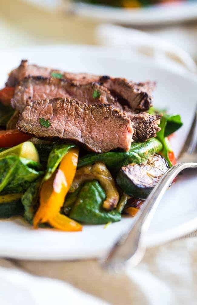 Paleo grilled beef with Asian almond dressing- beef and vegetarians are grilled and then thrown cream Asian almond butter vinaigrette and spinach for fast and easy and healthy, paleo friendly food! | Foodfaithfitlness.com | @Foodfaithfit