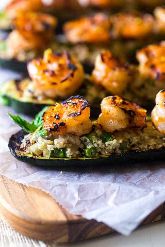 close up of shrimp zucchini boats on parchment paper