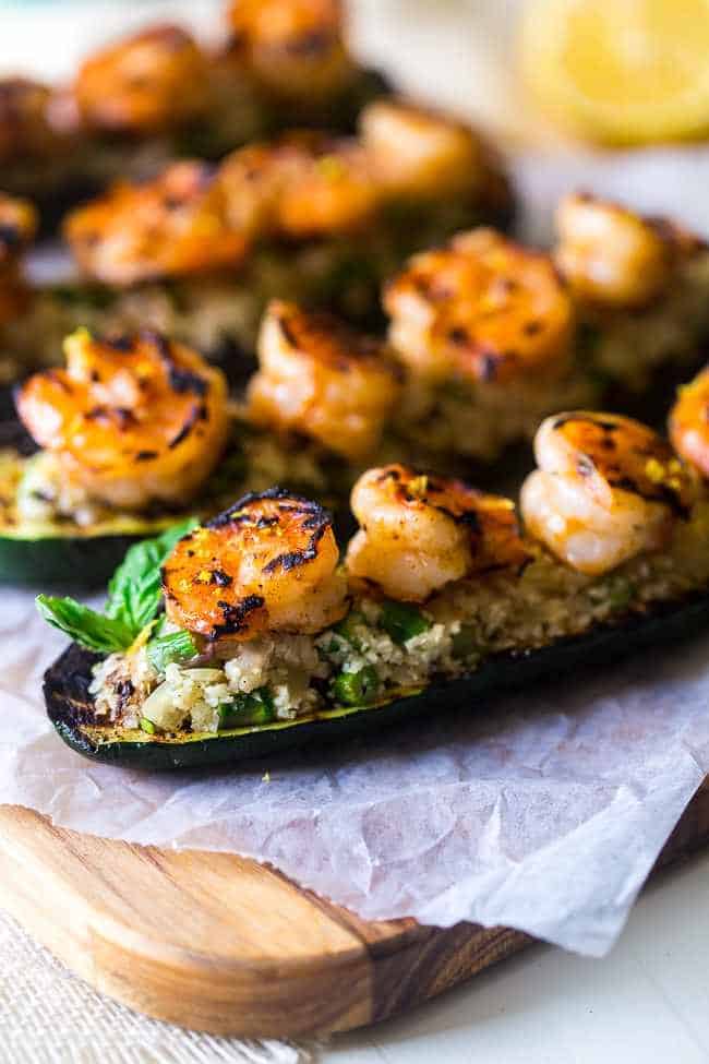 shrimp zucchini boats on a cutting bored