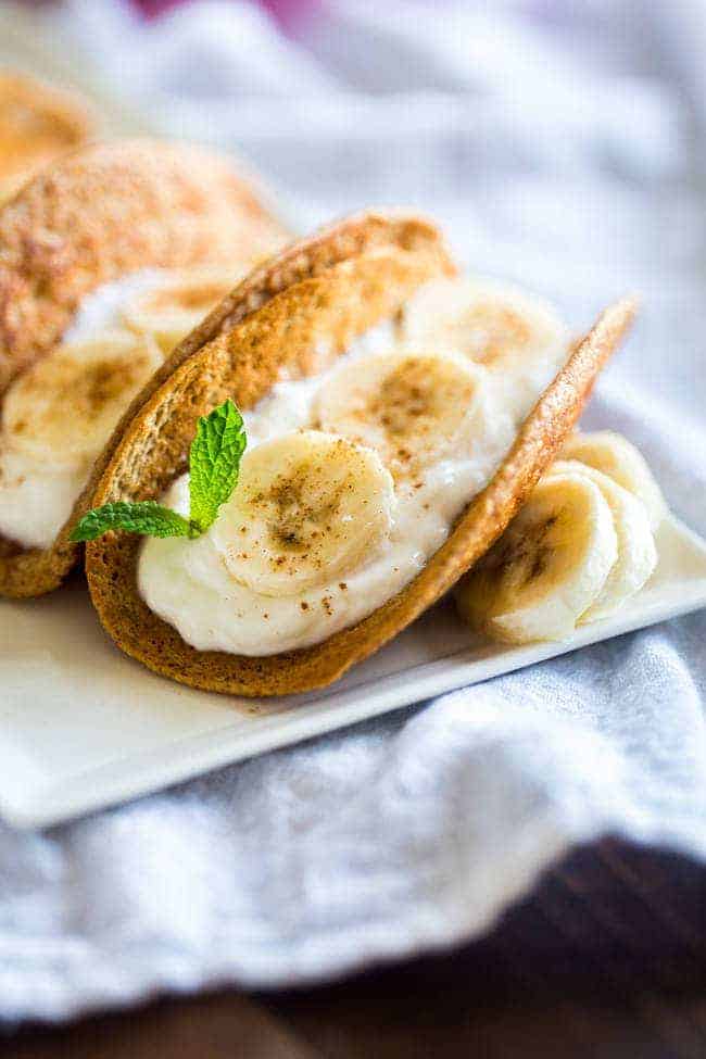 Greek Yogurt Banana Pancake Tacos - These gluten free banana pancakes are filled with Greek yogurt and rolled up like tacos! They're a fun, healthy breakfast for only 100 calories per taco! | Foodfaithfitness.com | @FoodFaithFit