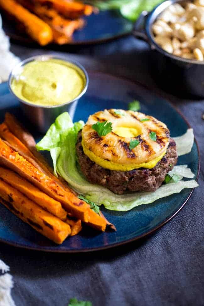 Paleo Burgers with Grilled Pineapple and Curry Cashew Cream - Topped with smooth and spicy curry cashew cream, grilled pineapple and wrapped with lettuce, this burger is a low carb, healthy meal for under 250 calories! | Foodfaithfitness.com | @FoodFaithFit