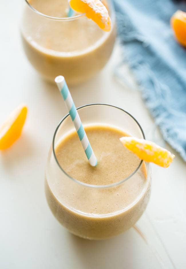 Banana Creamsicle Protein Smoothie - This orange smoothie is SO thick, creamy, and packed with vanilla protein powder so it tastes like a creamsicle! Ready in 5 minutes, loading with antioxidants and perfect for post workout recovery! | Foodfaithfitness.com | @FoodFaithFit
