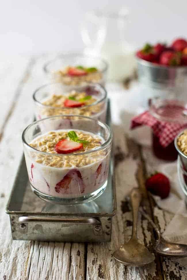 Strawberry Cheesecake Overnight Oats - These overnight oats are layered with a mixture of strawberry jam, cream cheese and Greek yogurt for a quick and easy, high-protein breakfast that feels like dessert! | Foodfaithfitness.com | @FoodFaithFit