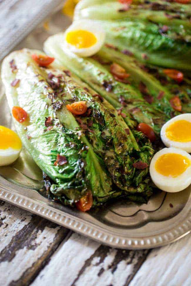 BLT Grilled Wedge Salads with Lemon Dill Vinaigrette - Grilled romaine hearts are tossed with turkey bacon, tomato, soft boiled eggs and a creamy, homemade lemon dill dressing! It's a low carb, healthy summer meal for 300 calories! | Foodfaithfitness.com | @FoodFaithFit