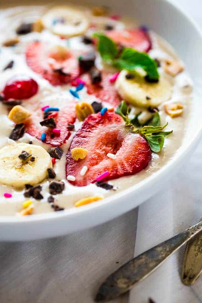 Banana Split Vegan Smoothie Bowl - This vegan smoothie bowl is made with only 5 ingredients, ready in 5 minutes, tastes like a banana split, and is secretly healthy enough for breakfast! | #Foodfaithfitness | #Glutenfree #Vegan #Healthy #paleo #dairyfree extreme close up of vegan smoothie bowl with sprinkles on top
