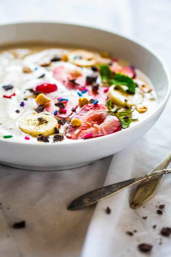side view of vegan smoothie bowl in a dish with a spoon on the side