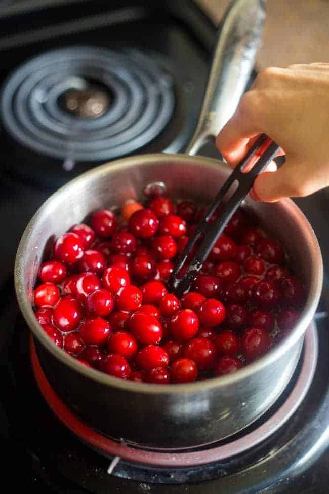 Paleo Maple Orange Cranberry Sauce - This healthy, homemade cranberry sauce uses only 3 ingredients and is Paleo friendly and refined- sugar free! It's ready in 30 minutes and is perfect for Thanksgiving! | Foodfaithfitness.com| @FoodFaithFit