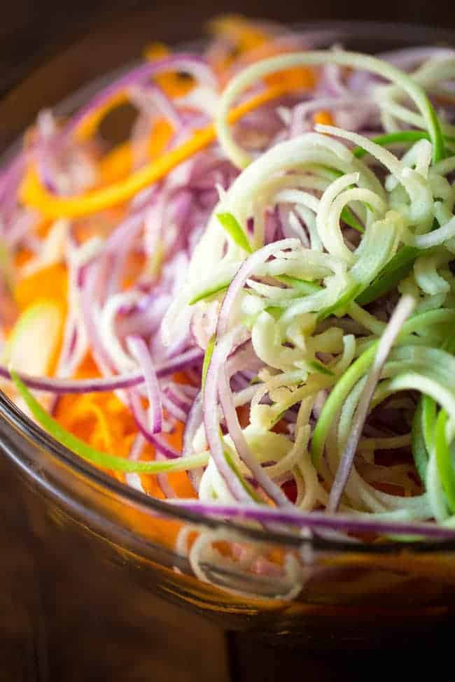 Paleo & Vegan Curried Maple Spiralized Apple and Butternut Squash Salad - This salad is full of apples, dates and pecans. It has a spicy-sweet flavor and is a healthy, paleo and vegan friendly side dish! Perfect for Thanksgiving! | Foodfaithfitness.com | @FoodFaithFit