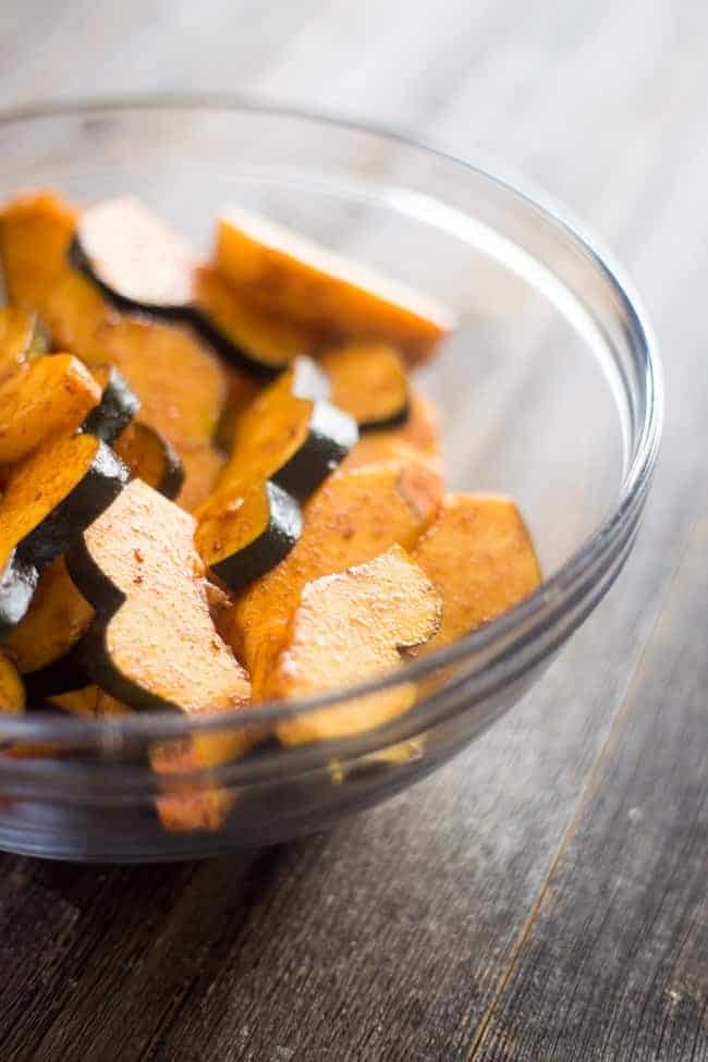Vegan Maple Tahini Orange Roasted Acorn Squash and Cranberry Quinoa Salad - This healthy salad is mixed with maple roasted acorn squash, cranberries and oranges for a fall meal that is gluten free and vegan friendly. Perfect for Thanksgiving of Friendsgiving! | Foodfaithfitness.com | @FoodFaithFit