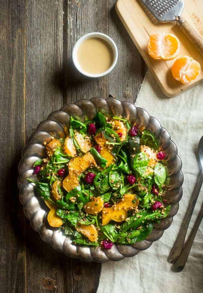 Vegan Maple Tahini Orange Roasted Acorn Squash and Cranberry Quinoa Salad - This healthy salad is mixed with maple roasted acorn squash, cranberries and oranges for a fall meal that is gluten free and vegan friendly. Perfect for Thanksgiving of Friendsgiving! | Foodfaithfitness.com | @FoodFaithFit