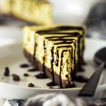 Gluten Free Brownie Bottomed Mint Chocolate Avocado Cheesecake - This creamy gluten free cheesecake uses avocado to make it naturally green. It has a rich brownie bottom crust and you'll never know it's secretly healthy! Perfect for Christmas! | Foodfaithfitness.com | @FoodFaithFit