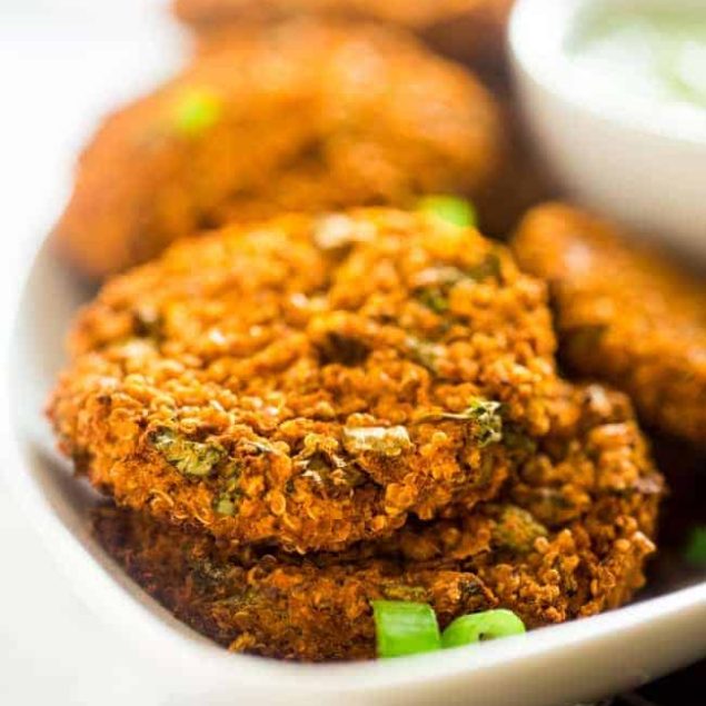 Vegan Buffalo Patties with Avocado Dip - These patties taste just like buffalo chicken, but they're totally meat free and made with cauliflower and quinoa! They're a spicy, crunchy and creamy appetizer for game day! | Foodfaithfitness.com | @FoodFaithFit