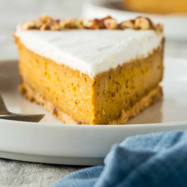 Gluten Free Paleo And Vegan Carrot Cake Cheesecake - This super easy, rich, creamy, paleo and vegan friendly cheesecake tastes like carrot cake but is secretly dairy, gluten, egg and refined sugar free and healthy! Perfect for Easter! | Foodfaithfitness.com | @FoodFaithFit