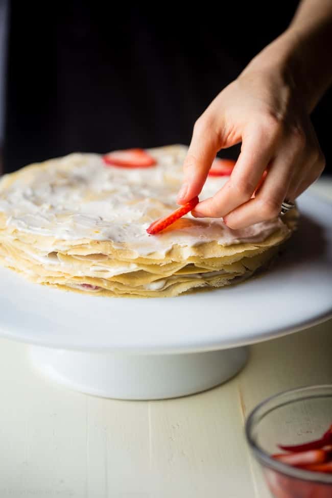 Strawberry Lemon Paleo Crepe Cake with Coconut Cream - This cake is made out of paleo crepes layered with rich, sweet lemon coconut cream and fresh strawberries. It's a gluten free dessert, that's perfect for a spring brunch or Mothers day! | Foodfaithfitness.com | @FoodFaithFit