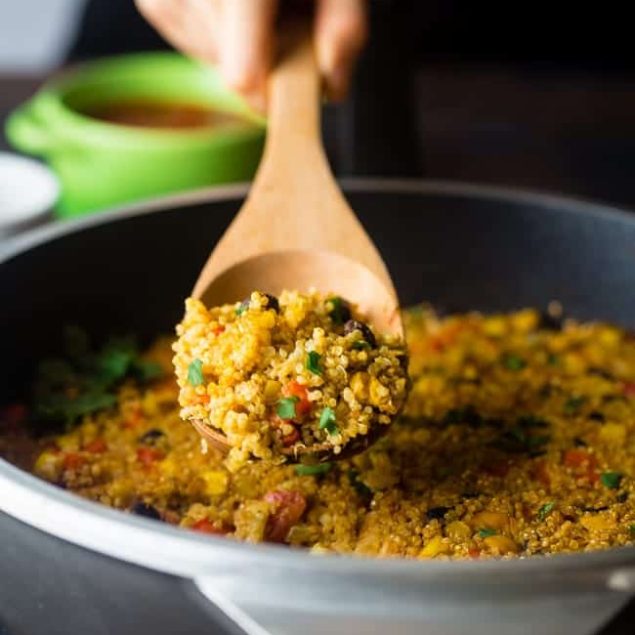 Vegan "Cheesy" Mexican Quinoa - This easy, one-pan meal has a spicy, cheesy taste - without the cheese! It's a healthy and gluten free, vegan-friendly weeknight meal that is under 300 calories! | Foodfaithfitness.com | @FoodFaithFit