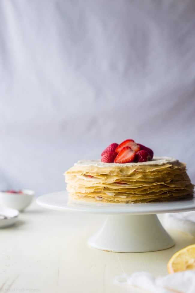 Strawberry Lemon Paleo Crepe Cake with Coconut Cream - This cake is made out of paleo crepes layered with rich, sweet lemon coconut cream and fresh strawberries. It's a gluten free dessert, that's perfect for a spring brunch or Mothers day! | Foodfaithfitness.com | @FoodFaithFit