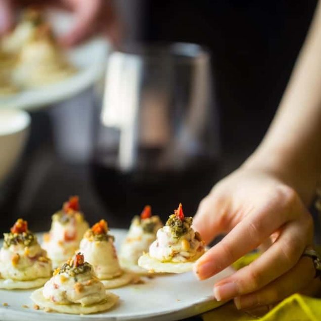 Sun-Dried Tomato Hummus and Goat Cheese Pesto Bites - These quick and easy bites use creamy goat cheese and tangy hummus! They're a healthy, spring appetizer that are only 40 calories and 1 SmartPoint! | Foodfaithfitness.com | @FoodFaithFit