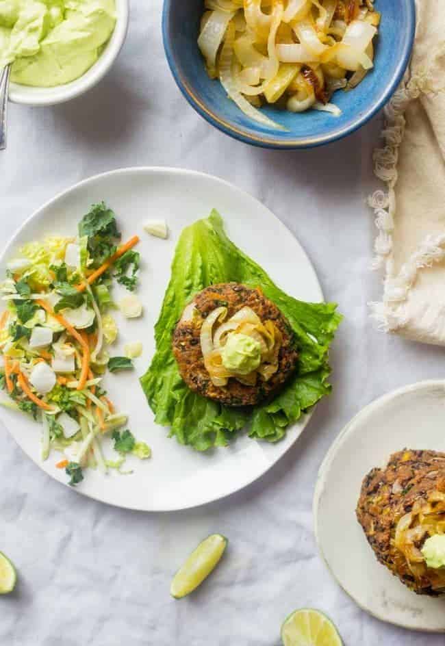Black Bean Power Burger with Avocado Crema - This black bean burger is so tender and juicy you would never know it's meatless! Load it up with caramelized onions and avocado crema for a healthy, gluten free meal that's easy to prepare! | Foodfaithfitness.com | @FoodFaithFit