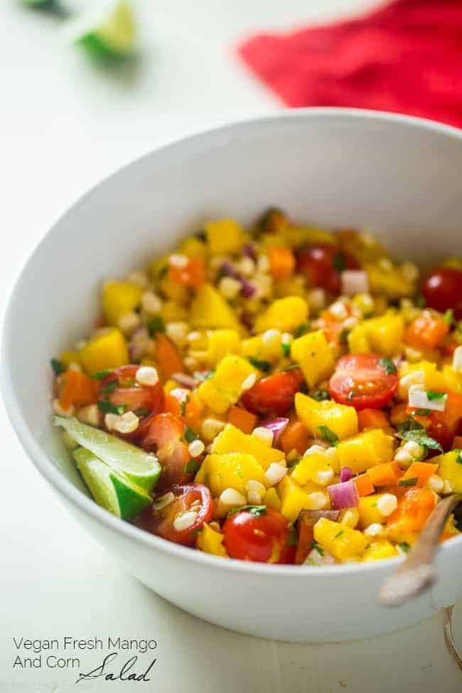 Vegan Fresh Corn and Mango Salad - This healthy salad has fresh corn, juicy, sweet mangos and tons of crispy, fresh vegetables! It's the perfect, quick and easy side dish for summer that is under 100 calories! | Foodfaithfitness.com | @FoodFaithFit