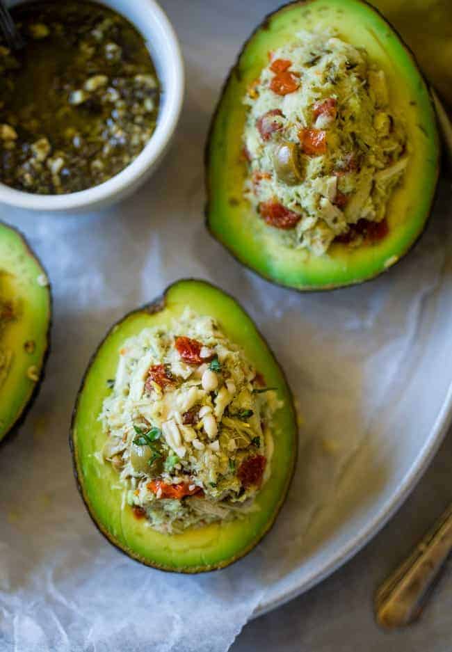 Mediterranean Healthy Tuna Salad Stuffed Avocados - This tuna salad has a Mediterranean twist and is served in an avocado! It has no mayo and is an easy, gluten free and low carb meal with only 6 ingredients! | Foodfaithfitness.com | @FoodFaithFit