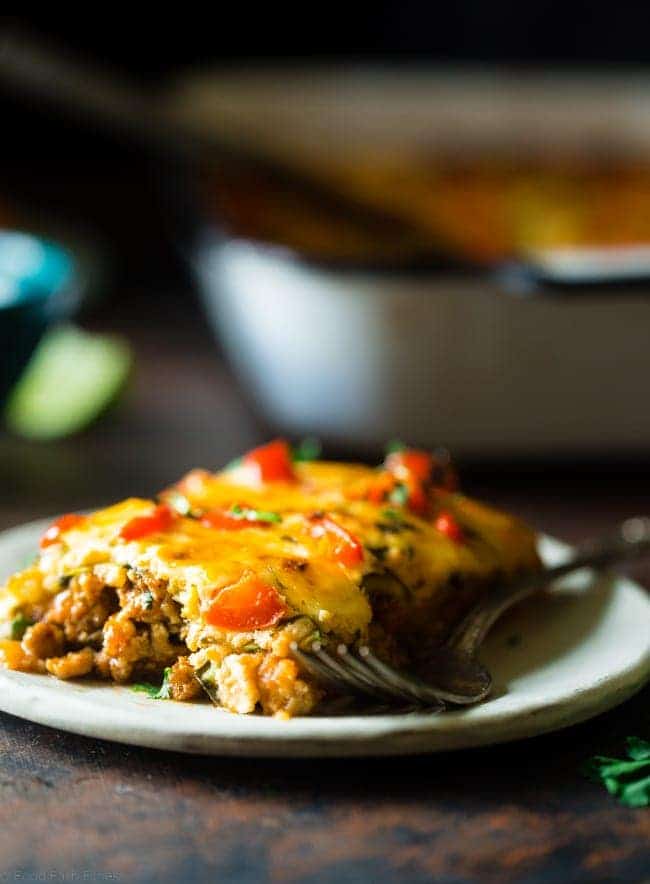 Mexican Zucchini Lasagna - This lasagna has all the cheesy, saucy taste but without the carbs and calories! It's a healthy, gluten free and protein-packed crowd-pleasing dinner that's only 280 calories! Make-ahead and freezer friendly too! | Foodfaithfitness.com | @FoodFaithFit