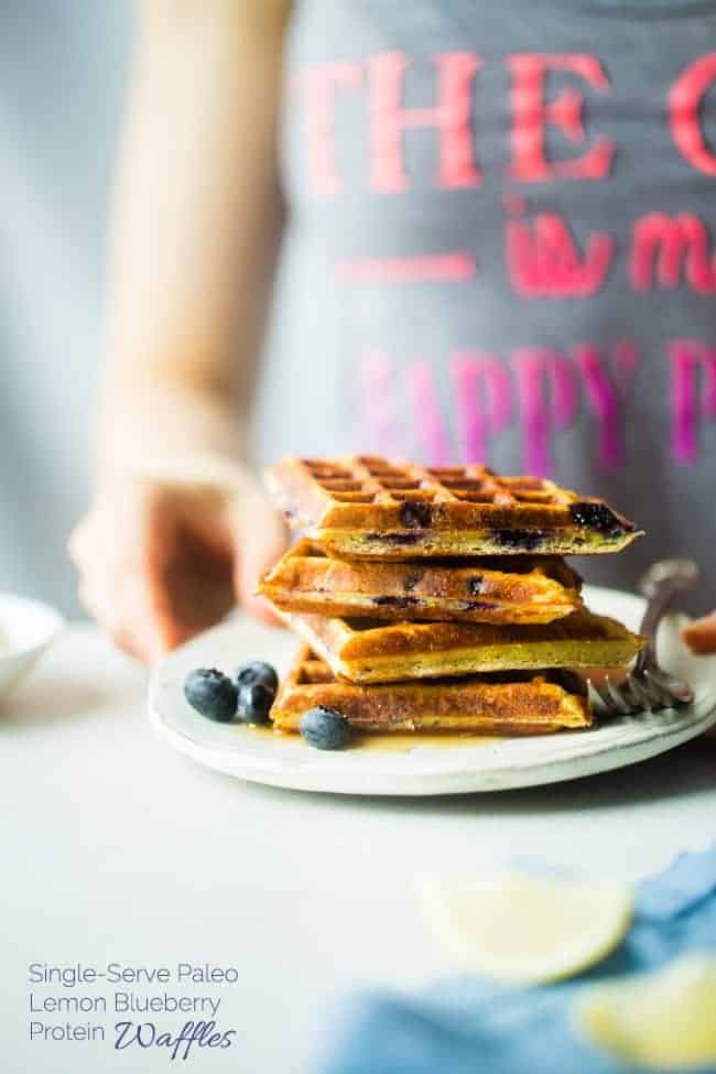 Single-Serve Lemon Blueberry Paleo Protein Waffles - These single-serve protein waffles are studded with juicy blueberries and have a 5 minute lemon sauce! Perfect for a paleo friendly, gluten free breakfast on busy mornings! | FoodFaithfitness.com | @FoodFaithFit