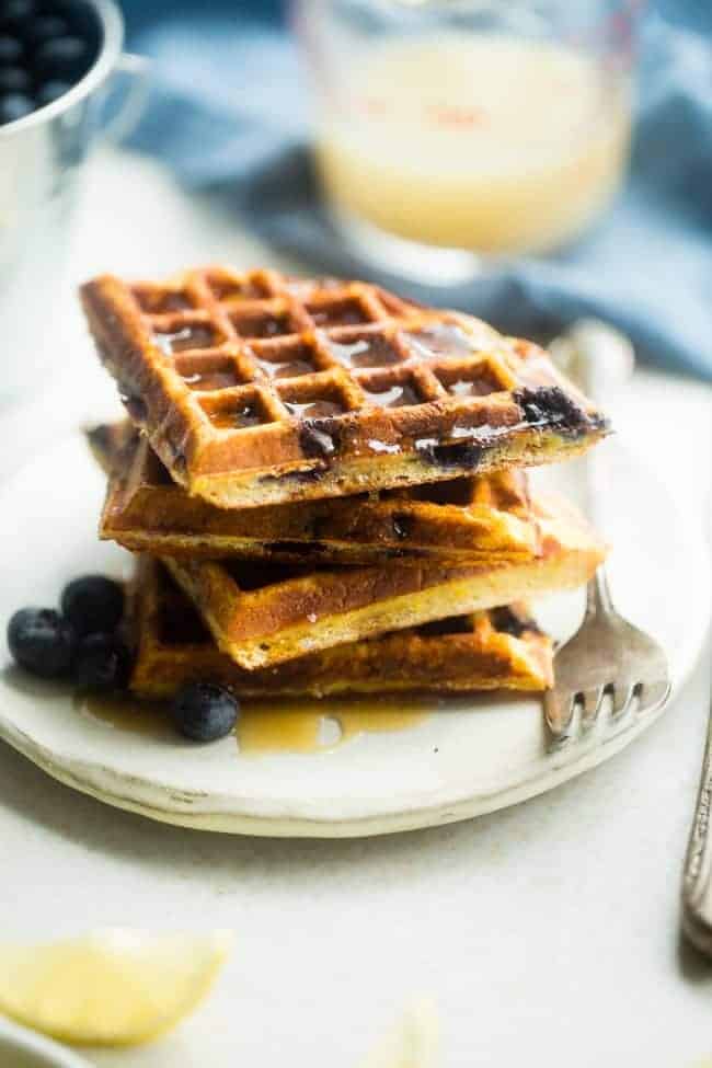 Single-Serve Lemon Blueberry Paleo Protein Waffles - These single-serve protein waffles are studded with juicy blueberries and have a 5 minute lemon sauce! Perfect for a paleo friendly, gluten free breakfast on busy mornings! | FoodFaithfitness.com | @FoodFaithFit