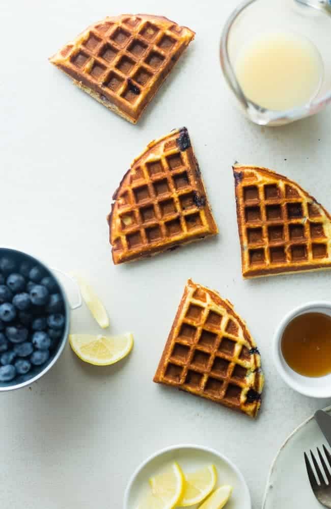 Single-Serve Lemon Blueberry Paleo Protein Waffles - These single-serve protein waffles are studded with juicy blueberries and have a 5 minute lemon sauce! Perfect for a paleo friendly, gluten free breakfast on busy mornings! | FoodFaithfitness.com | @FoodFaithFit