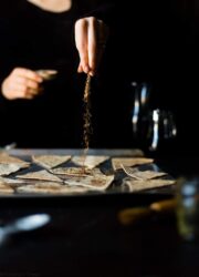 Sprinkling coffee and sugar onto flatbread pieces for healthy pumpkin pie dip chips.