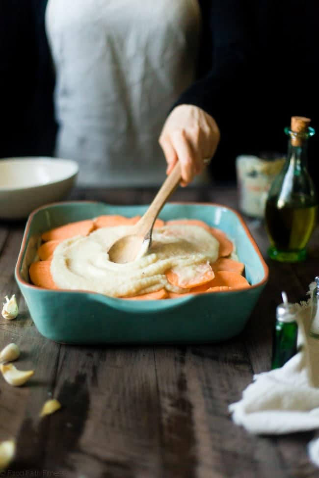 Cauliflower Alfredo Vegan Scalloped Sweet Potatoes - This whole30 compliant side dish is so creamy you'll never know they're under 200 calories, paleo friendly and have hidden veggies! Perfect for Thanksgiving! | Foodfaithfitness.com | @FoodFaithFit
