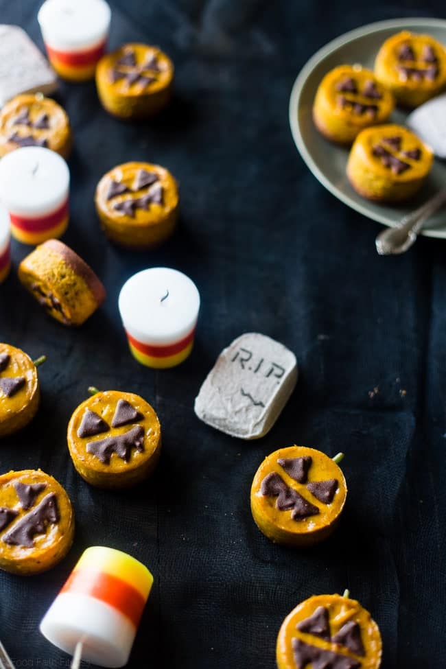 Vegan Mini Pumpkin Jack-O-Lantern Cheesecakes - These pumpkin vegan cheesecakes are easy to make, and are perfect for Halloween! They're healthy, gluten free, paleo friendly and only 200 calories! | Foodfaithfitness.com | @FoodFaithFit